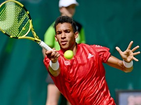 Felix Auger-Aliassime of Canada plays a forehand in his match against Roger Federer of Switzerland during the Noventi Open at OWL-Arena on June 16, 2021 in Halle, Germany.