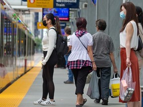 Calgarians ride the CTrain in downtown Calgary on Sunday, June 20, 2021. Council will be looking at when to lift the current mandatory mask bylaw this summer.