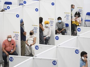 People receive their COVID-19 vaccine at the 'hockey hub' mass vaccination facility at the CAA Centre during the COVID-19 pandemic.