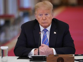 In this file photo taken June 26, 2020, then U.S. President Donald Trump looks on during an American Workforce Policy Advisory Board Meeting in the East Room of the White House in Washington, D.C.