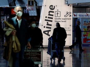 Travellers walk with their luggage at Fiumicino Airport near Rome, Italy, May 17, 2021.