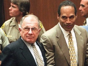 Murder defendant O.J. Simpson, right, listens to the not guilty verdict with his attorney F. Lee Bailey.