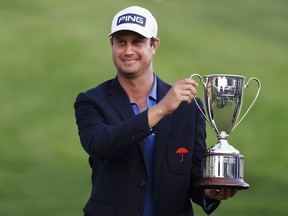 Harris English of the United States poses with the trophy after winning the Travelers Championship on the eighth playoff hole over Kramer Hickok of the United States (not pictured) at TPC River Highlands on June 27, 2021 in Cromwell, Conn.