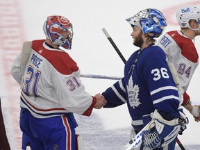 Toronto Maple Leafs goalie Jack Campbell (36) shakes hands with Montreal Canadiens goalie Carey Price (31) after Montreal won 3-1 in game seven of the first round of the 2021 Stanley Cup Playoffs at Scotiabank Arena.