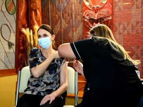 New Zealand Prime Minister Jacinda Ardern receives her first COVID-19 vaccination in Auckland, June 18, 2021.