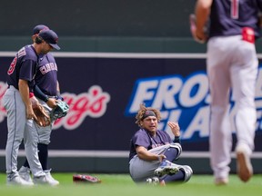 Cleveland Indians outfielder Josh Naylor (on ground) calls for medical attention after colliding with second baseman Ernie Clement (28) in the fourth inning against the Minnesota Twins at Target Field, in Minneapolis, Minn., Sunday, June 27, 2021.