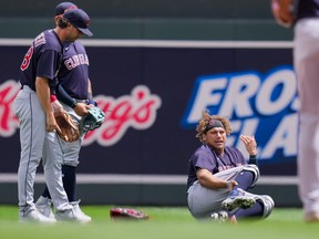 Cleveland Indians outfielder Josh Naylor calls for medial attention after colliding with second baseman Ernie Clement in the fourth innings against the Minnesota Twins at Target Field in Minneapolis, June 27, 2021.