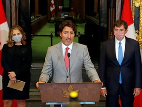 Prime Minister Justin Trudeau speaks to reporters next to Deputy PM and Finance Minister Chrystia Freeland and Minister of Intergovernmental Affairs Dominic LeBlanc on Parliament Hill in Ottawa, Aug. 18, 2020.