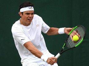 Milos Raonic plays a backhand in his fourth round match against Guido Pella at Wimbledon, in London, July 8, 2019.