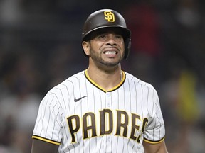 Padres batter Tommy Pham grimaces after being hit with a pitch during the fifth inning of a game against the Diamondbacks at Petco Park in San Diego, Saturday, June 26, 2021.