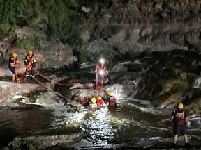 Technicians from Ottawa Fire Services rescue a man in the water at Hog's Back Falls on the night of June 13, 2021. SOURCE: Ottawa Fire Services