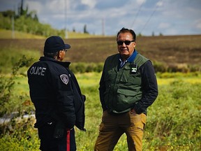Undated, handout photo of Steve Sxwithul'txw talking to Cst. Willy Big Smoke of the Tsuut'ina Police (Tsuut'ina Nation, southern Alberta).