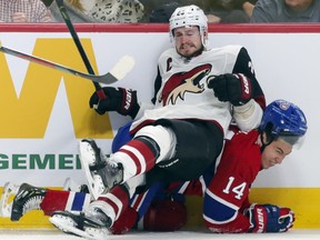 Oliver Ekman-Larsson of Arizona falls on Nick Suzuki during Feb.10, 2020 game in Montreal.