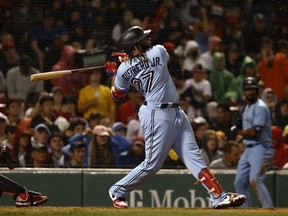 Vladimir Guerrero Jr. of the Toronto Blue Jays follows through on a three-run home run against the Boston Red Sox during the fifth inning at Fenway Park on July 29, 2021 in Boston, Massachusetts.