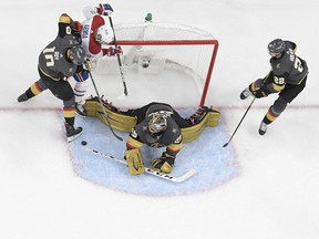 File photo/ Marc-Andre Fleury #29 of the Vegas Golden Knights gets assistance from Nicolas Roy #10 and Nick Holden #22 while blocking a shot by Joel Armia #40 of the Montreal Canadiens during the second period in Game Five of the Stanley Cup Semifinals at T-Mobile Arena on June 22, 2021 in Las Vegas, Nevada. The Canadiens beat the Golden Knights 4-1.
