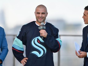 SEATTLE, WASHINGTON - JULY 21: (L-R) Former NHL player Dominic Moore, Mark Giordano and broadcaster Chris Fowler attend the 2021 NHL expansion Draft at the Gas Works Park on July 21, 2021 in Seattle, Washington. The Kraken is the National Hockey League's newest franchise and will begin play in October 2021.