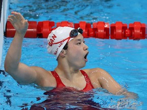 Maggie Mac Neil celebrates after winning Canada's first golf medal at Tokyo 2020.