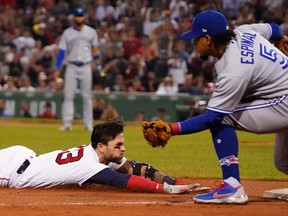 Boston Red Sox second baseman Michael Chavis dives into third base for a triple against Toronto Blue Jays third baseman Santiago Espinal (5) in the sixth inning during game two of a double header at Fenway Park.