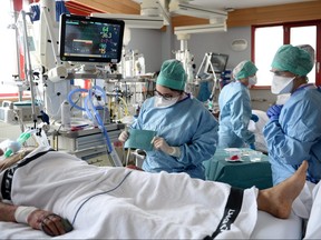 Medical workers work in the Intensive Care Unit (ICU) where patients suffering from COVID-19 are treated at the Saint-Pierre clinic in Ottignies, Belgium, April 7, 2021.