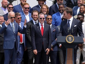 U.S. President Joe Biden reacts to a quip from Tampa Bay Buccaneers quarterback Tom Brady during a reception for the team at the White House in Washington July 20, 2021.
