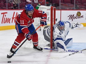 Montreal Canadiens winger Brendan Gallagher (11) controls the puck as Tampa Bay Lightning goaltender Andrei Vasilevskiy (88) defends the net at the Bell Centre