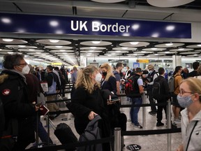 Arriving passengers queue at U.K. Border Control at the Terminal 5 at Heathrow Airport in London, June 29, 2021.