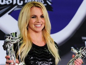 In this file photo, Britney Spears holds her Best Pop Video Award and her Michael Jackson Video Vanguard Award in the press room at the 2011 MTV Video Music Awards at the Nokia Theater in downtown Los Angeles, Aug. 28, 2011.