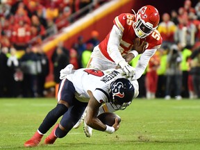 Deshaun Watson of the Houston Texans is tackled by Frank Clark of the Kansas City Chiefs at Arrowhead Stadium on January 12, 2020 in Kansas City, Missouri.