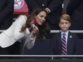 Britain's Catherine (L), Duchess of Cambridge, talks with Prince George of Cambridge (C), as Britain's Prince William (R), Duke of Cambridge, looks on during the UEFA EURO 2020 final football match between Italy and England at the Wembley Stadium in London on July 11, 2021.