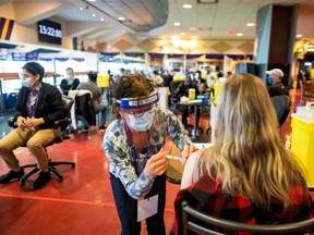 A health-care worker administers the Pfizer/BioNTech coronavirus disease (COVID-19) vaccine, which was authorized by Canada to be used for children aged 12 to 15, at Woodbine Racetrack pop-up vaccine clinic in Toronto May 5, 2021.