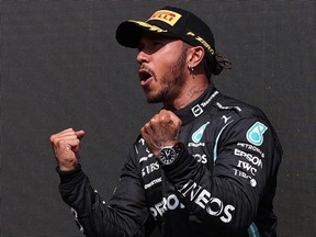 British Grand Prix race winner Lewis Hamilton celebrates on the podium at Silverstone motor racing circuit in Silverstone, England Sunday, July 18, 2021.
