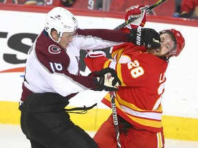 Nikita Zadorov tangles with Elias Lindholm in a playoff game between the Colorado Avalanche and Calgary Flames on April 19, 2019.