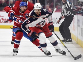 Montreal Canadiens forward Tomas Tatar (90) slashes Columbus Blue Jackets defenceman Seth Jones (3) at the Bell Centre