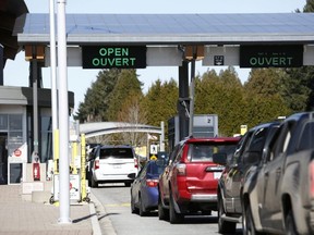 Drivers wait to cross through Canadian customs at the Canada-U.S. border near the Peace Arch Provincial Park in Surrey, B.C., March 16, 2020.