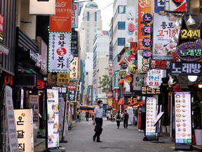 A man walks on a nearly empty street amid tightened social distancing rules due to the coronavirus disease (COVID-19) pandemic in Seoul, South Korea, July 12, 2021.