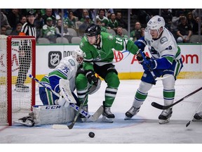 Nov 19, 2019; Dallas, TX, USA; Dallas Stars center Jason Dickinson (18) crashes into Vancouver Canucks goaltender Jacob Markstrom (25) as center Bo Horvat (53) defends during the second period at the American Airlines Center. Mandatory Credit: Jerome Miron-USA TODAY Sports