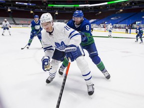 Vancouver Canucks forward J.T. Miller (9) checks Toronto Maple Leafs forward Zach Hyman (11) in the third period at Rogers Arena on March 6.