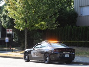 A police car remained at the scene of a sword attack Monday night near Spruce Street and West 12th Avenue in Vancouver.