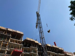 Firefighters and paramedics teamed up for a rope rescue of a construction worker suffering from heat-related symptoms Thursday