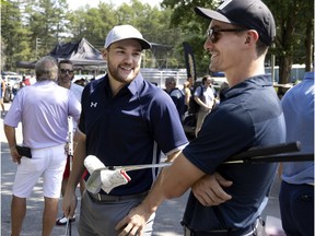 Montreal Canadiens winger Jonathan Drouin, left, and Laval Rocket centre Laurent Dauphin speak before the start of Canadiens head coach Dominique Ducharme's charity golf tournament in Joliette on Aug. 26, 2021.