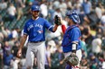 Toronto Blue Jays relief pitcher Jordan Romano (left) high-fives catcher Alejandro Kirk following a victory against the Seattle Mariners.