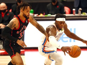 Toronto Raptors guard Gary Trent Jr., left, steals the ball from Oklahoma City Thunder forward Luguentz Dort during the second half at Amalie Arena in Tampa, Fla., April 18, 2021.