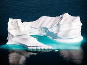 In this file photo taken on Aug. 15, 2019, an iceberg as it floats along the eastern cost of Greenland near Kulusuk (also spelled Qulusuk).