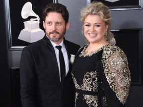 Kelly Clarkson and Brandon Blackstock arrive for the 60th Grammy Awards on Jan. 28, 2018, in New York.