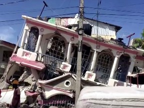 A view of a collapsed building following an earthquake, in Les Cayes, Haiti, in this still image taken from a video obtained by Reuters on Aug. 14, 2021.