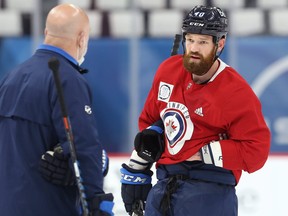 Winnipeg Jets defenceman Jordie Benn speaks with assistant coach Charlie Huddy after a collision with goaltender Laurent Brossoit during an optional practice in Winnipeg on Wed., June 2, 2021.