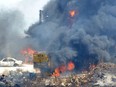 Vehicles burn outside the reported home of the lot owner, where the exploded fuel tank was placed, in the village of Tlel in Lebanon's northern region of Akkar on Aug. 15, 2021.