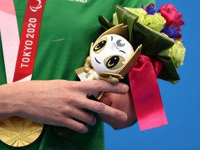 An athlete poses with the gold medal on the podium at the medal ceremony on Day 2 of the Tokyo 2020 Paralympic Games at the Tokyo Aquatics Centre on Aug. 26, 2021 in Tokyo.
