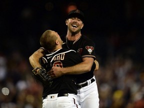 Diamondbacks starting pitcher Tyler Gilbert (right) celebrates with catcher Daulton Varsho (left) after throwing a no-hitter against the Padres at Chase Field in Phoenix, Saturday, Aug. 14, 2021.