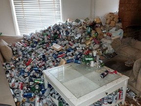 Thousands of empty beer cans piled on sofa.